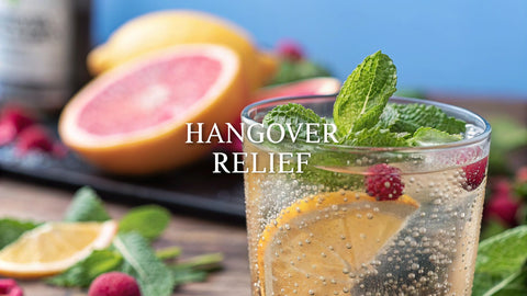 a close-up view of a cocktail with sliced fruit and the text 'hangover relief'