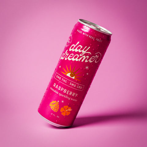 Pink can of 'day dreamer' raspberry sparkling water with THC and CBD text on a pink background