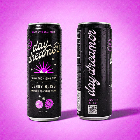 Two cans of 'day dreamer' berry bliss sparkling water on a purple background