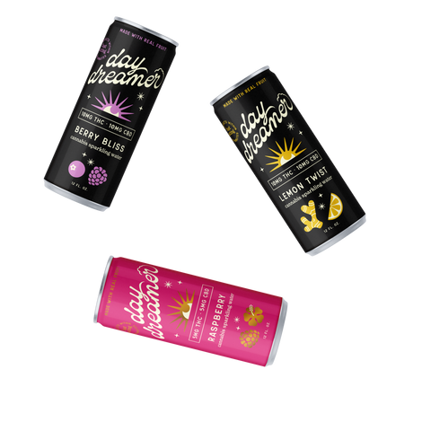 Three cans of Day Dreamer drinks in different flavors on a white background