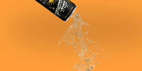 a black and yellow can of Day Dreamer Cannabis sparkling water pouring out in front of a yellow background