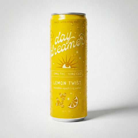 Yellow can of 'day dreamer' lemon twist sparkling water on a white background