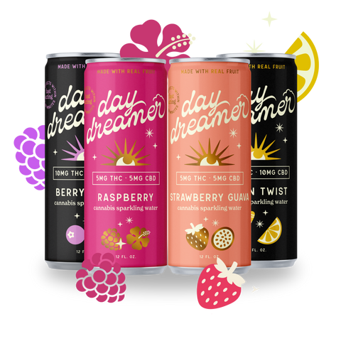 Four cans of 'day dreamer' sparkling water with different flavors on a white background.