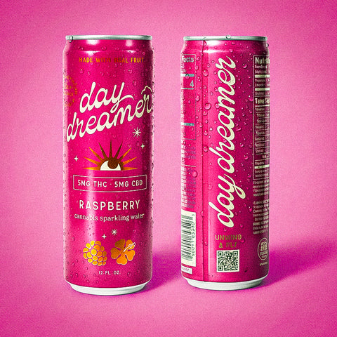 Two pink cans of 'day dreamer' raspberry sparkling water on a pink background