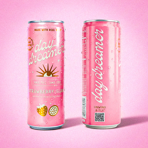 Two pink cans of 'day dreamer' sparkling water on a pink background